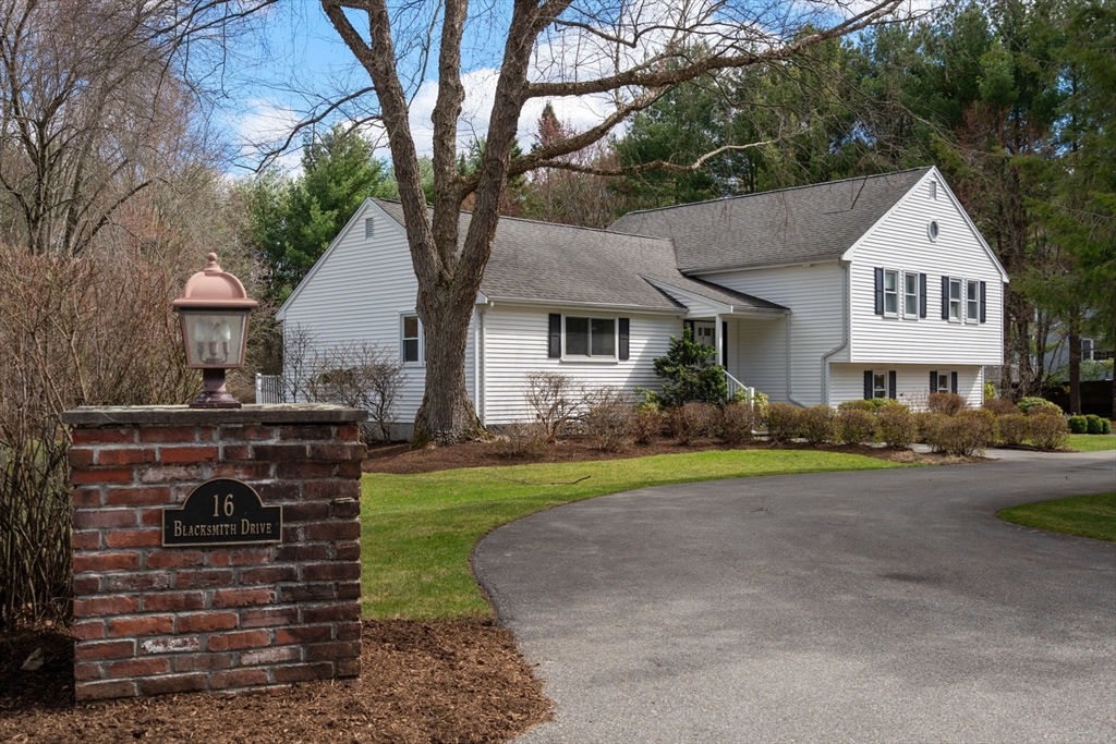 16 Blacksmith Drive Medfield, MA 02052 - Photo 1 of 40 a front view of a house with a yard and garage