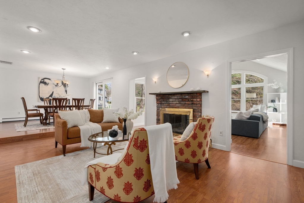 16 Blacksmith Drive Medfield, MA 02052 - Photo 15 of 40 a living room with fireplace furniture and a wooden floor