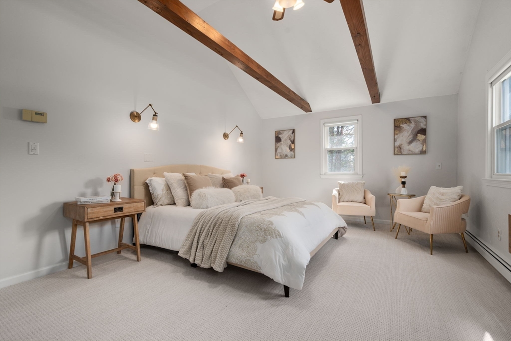 16 Blacksmith Drive Medfield, MA 02052 - Photo 20 of 40 a spacious bedroom with a bed and a couch