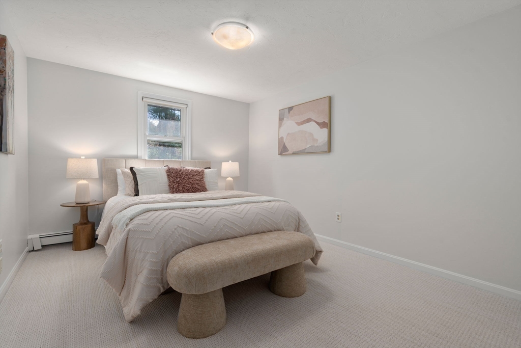 16 Blacksmith Drive Medfield, MA 02052 - Photo 22 of 40 a bedroom with a bed and a painting on the wall