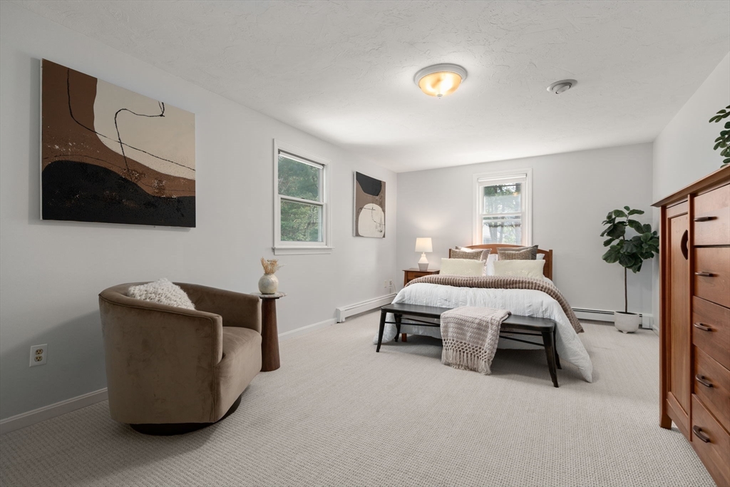 16 Blacksmith Drive Medfield, MA 02052 - Photo 24 of 40 a bedroom with a bed and a flat screen tv