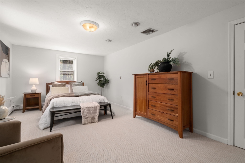 16 Blacksmith Drive Medfield, MA 02052 - Photo 25 of 40 a bedroom with a bed and a dresser
