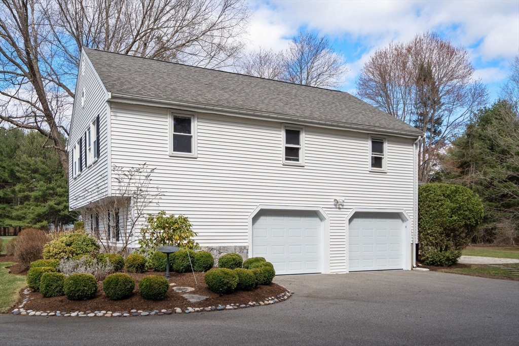 16 Blacksmith Drive Medfield, MA 02052 - Photo 34 of 40 a front view of a house with a yard and garage