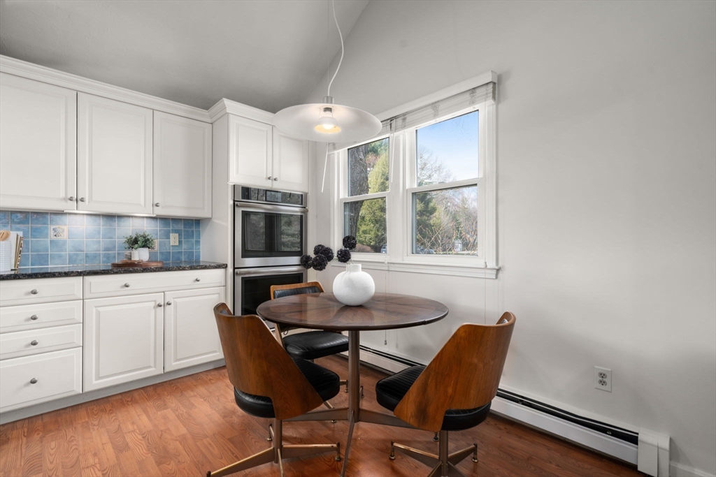 16 Blacksmith Drive Medfield, MA 02052 - Photo 10 of 40 a kitchen with a dining table chairs and window