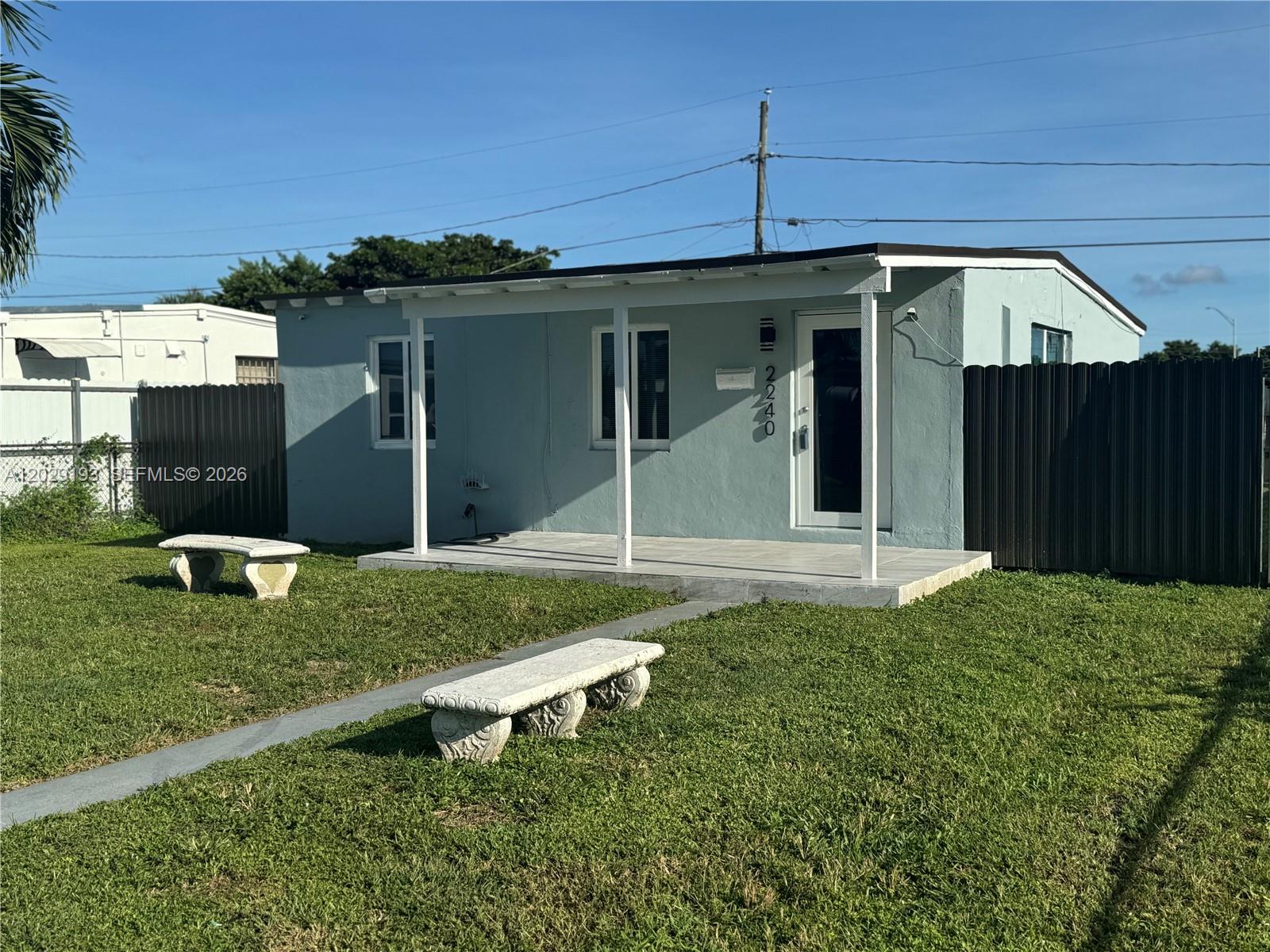 2240 Rutland Street Opa-Locka, FL 33054 - Photo 2 of 11 a backyard of a house with table and chairs