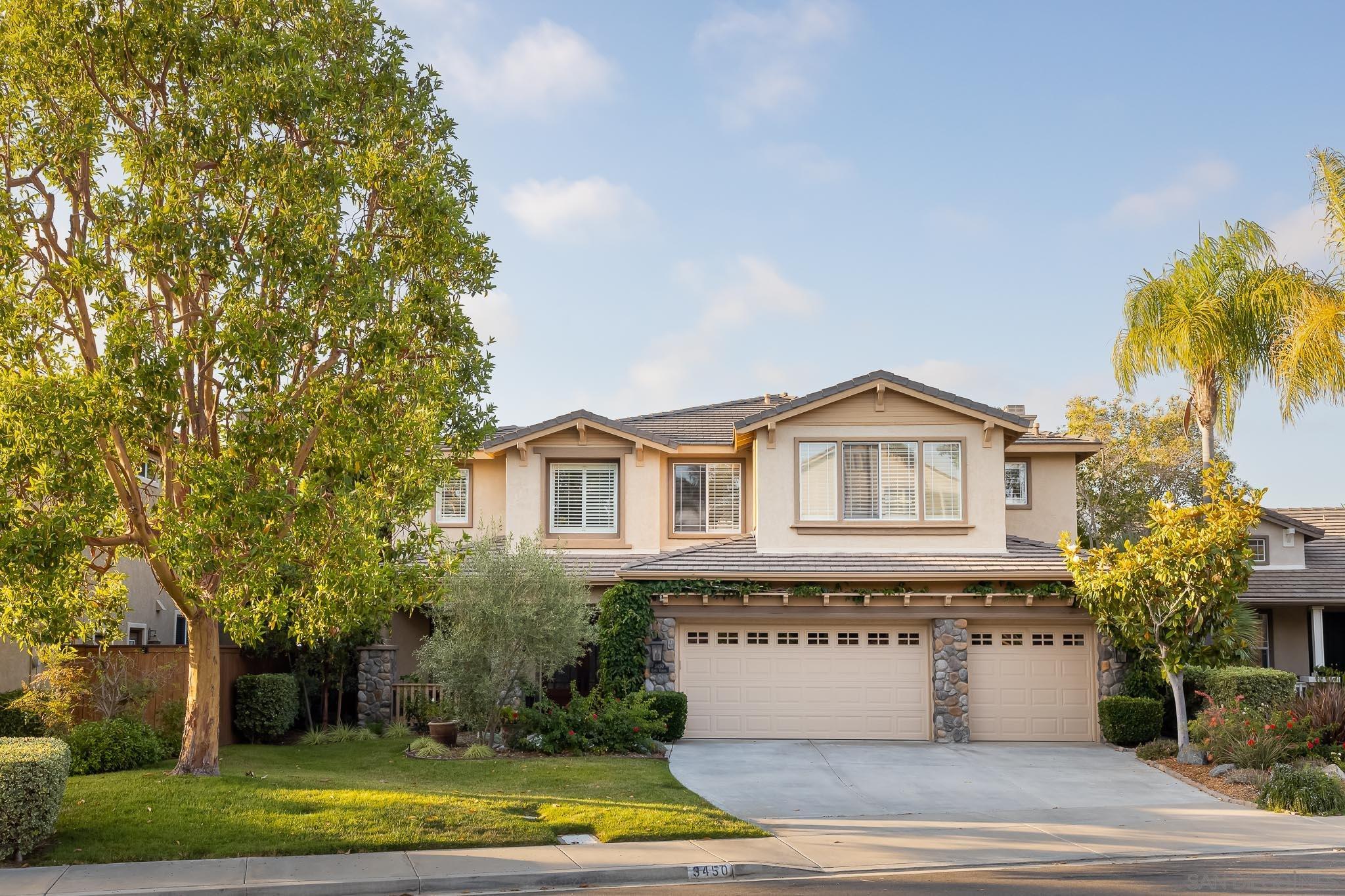 3450 Corte Clarita Carlsbad, CA 92009 - Photo 1 of 35 a front view of a house with a yard and garage