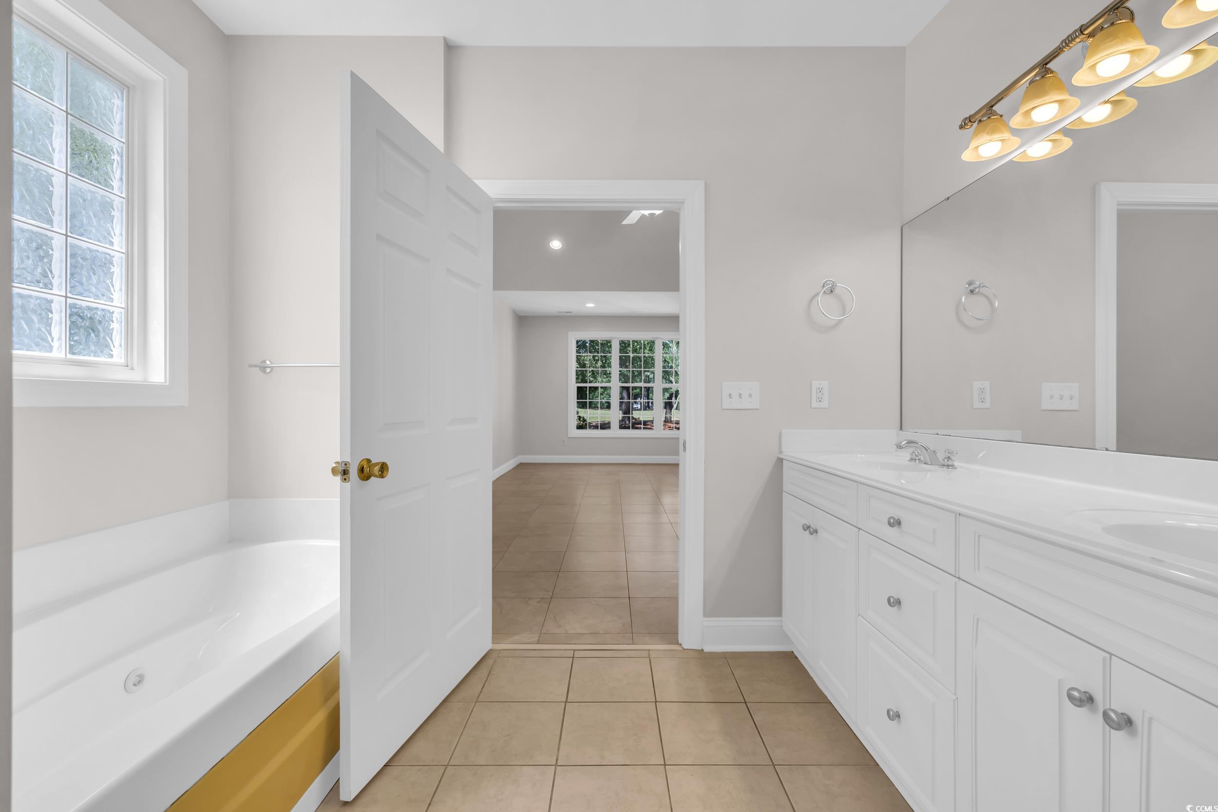 208 Lander Drive Conway, SC 29526 - Photo 12 of 40 Full bath featuring light tile patterned floors, a garden tub, and double vanity