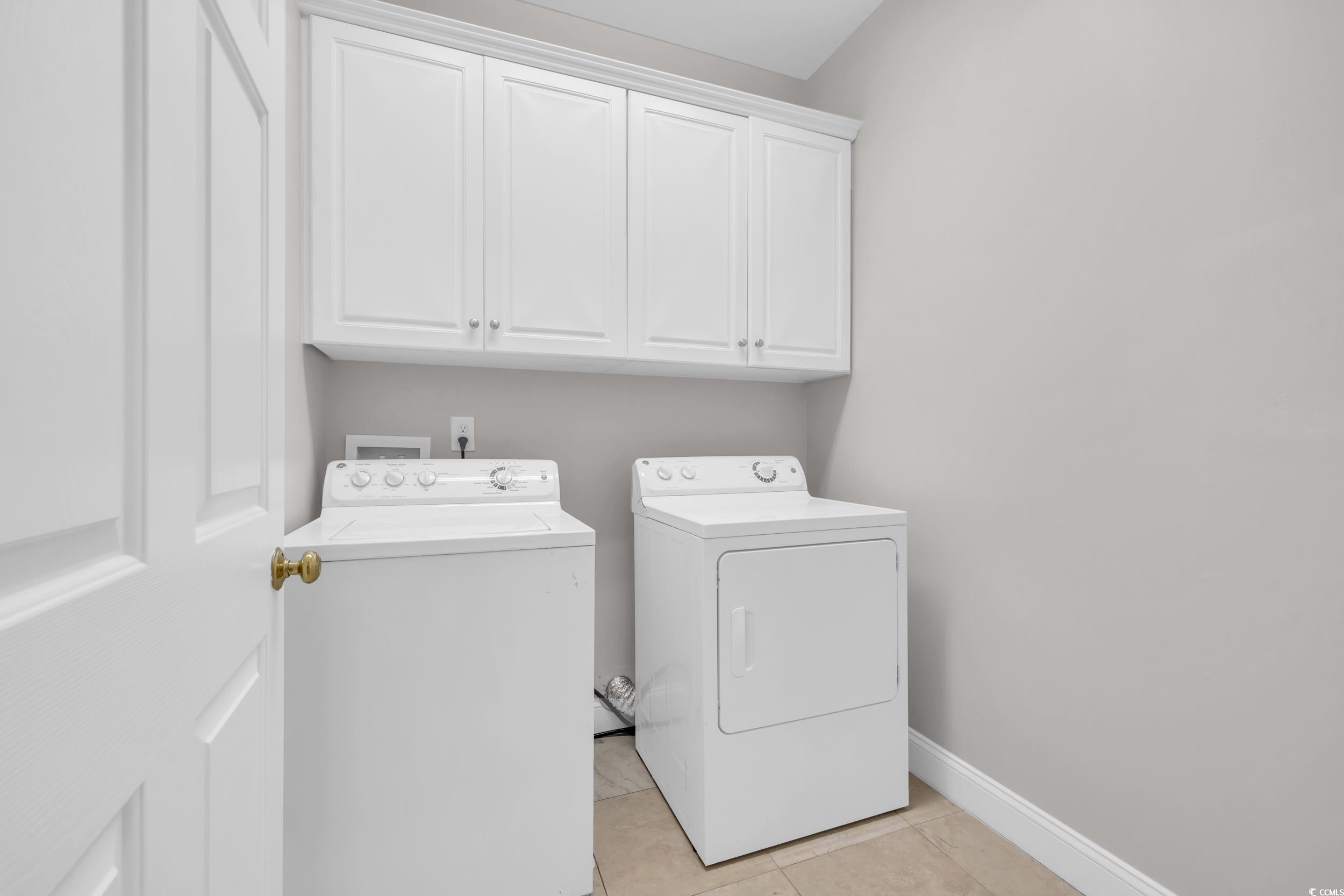 208 Lander Drive Conway, SC 29526 - Photo 14 of 40 Laundry area featuring light tile patterned flooring, cabinet space, and washing machine and clothes dryer