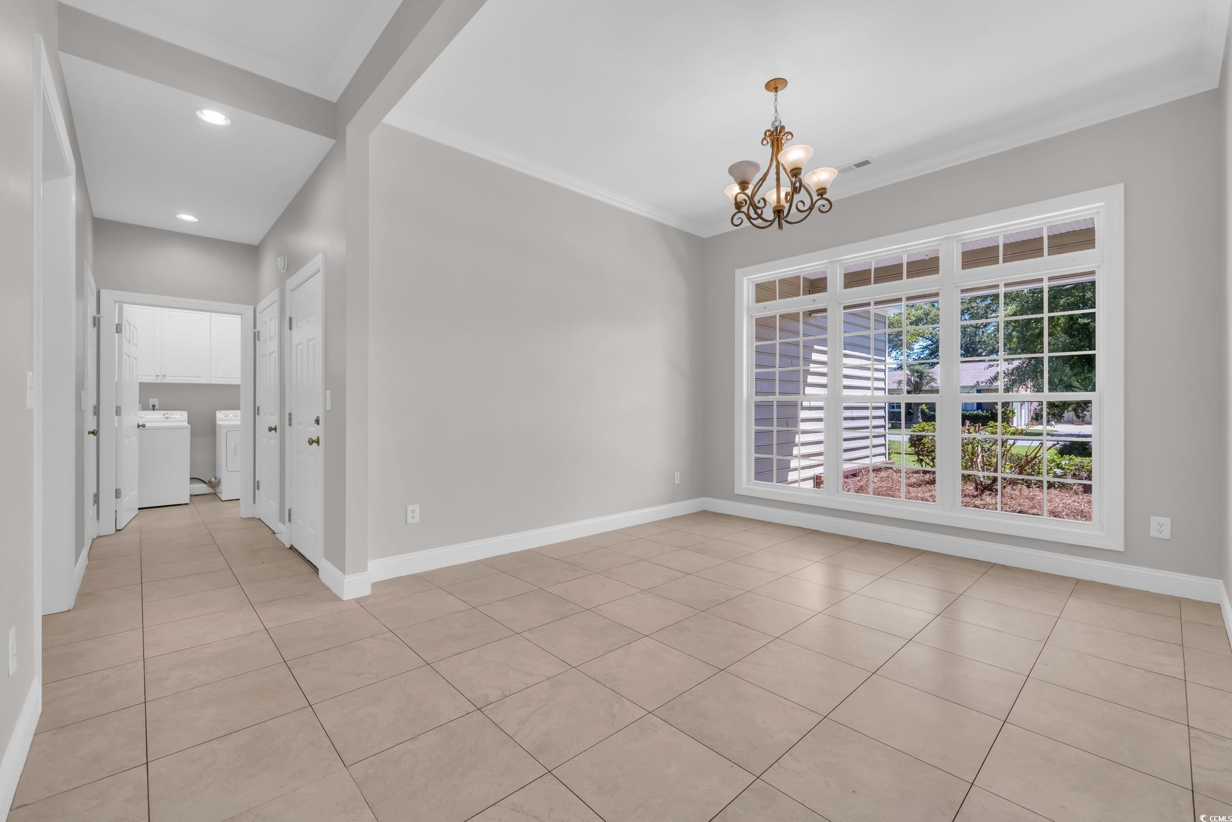 208 Lander Drive Conway, SC 29526 - Photo 15 of 40 Unfurnished dining area with light tile patterned flooring, ornamental molding, a chandelier, and recessed lighting