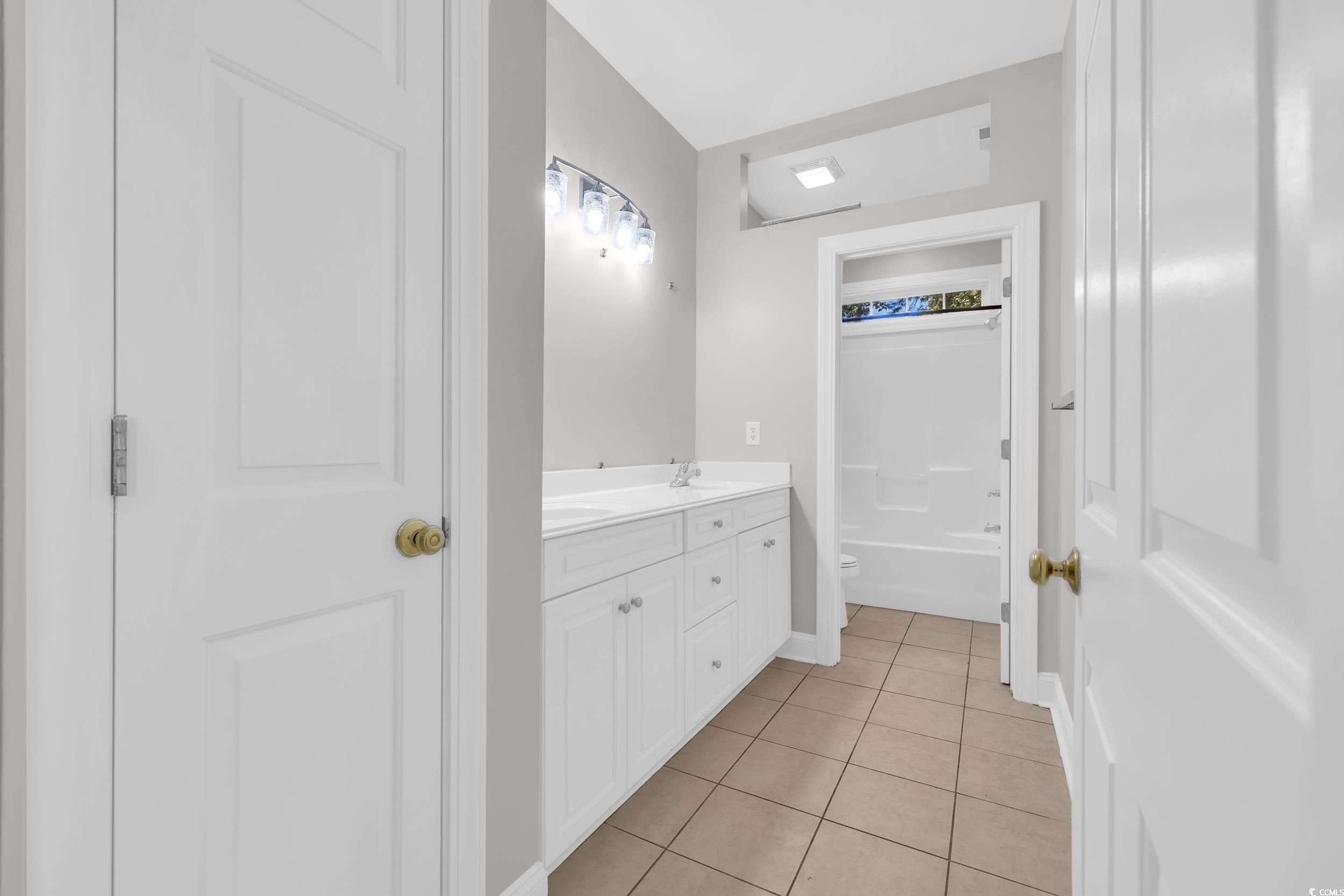 208 Lander Drive Conway, SC 29526 - Photo 19 of 40 Full bathroom featuring light tile patterned floors, vanity, and washtub / shower combination