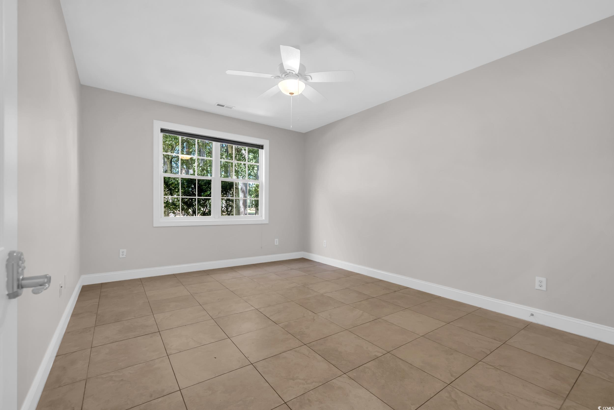 208 Lander Drive Conway, SC 29526 - Photo 20 of 40 Spare room featuring light tile patterned floors and ceiling fan
