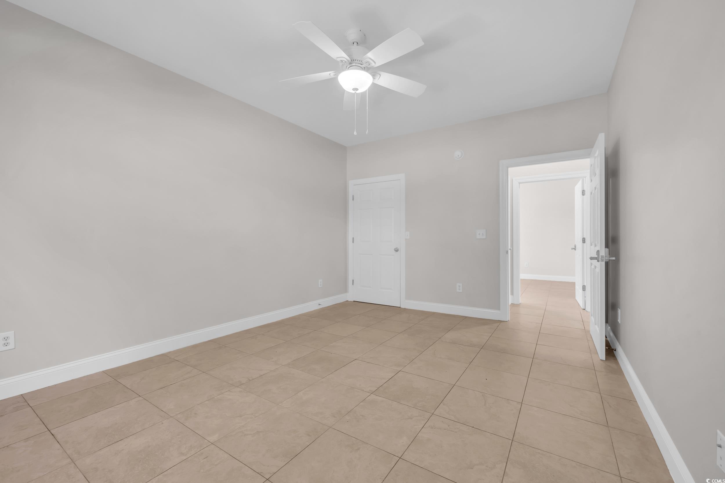 208 Lander Drive Conway, SC 29526 - Photo 21 of 40 Empty room featuring light tile patterned floors and ceiling fan