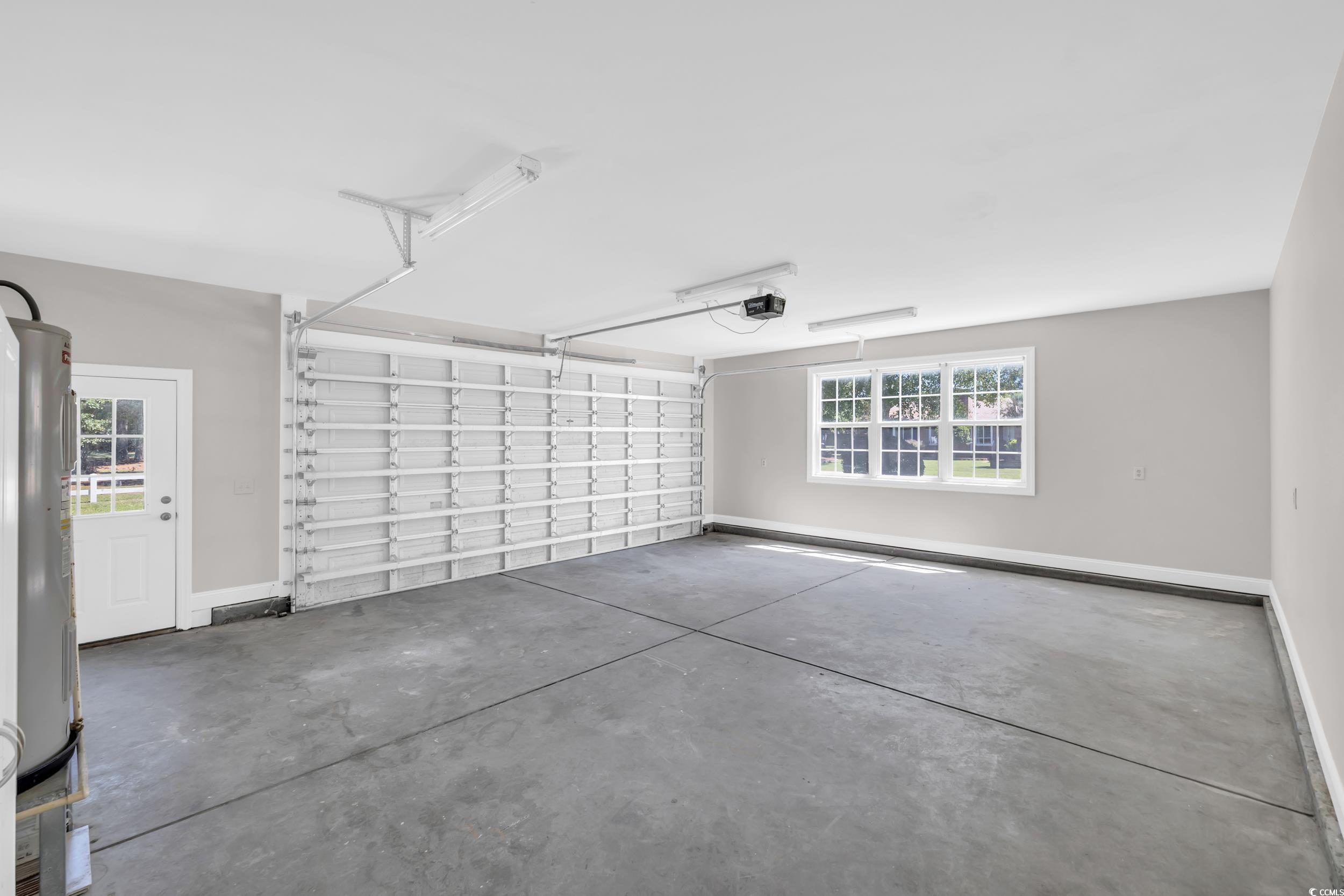 208 Lander Drive Conway, SC 29526 - Photo 34 of 40 Garage with baseboards and electric water heater
