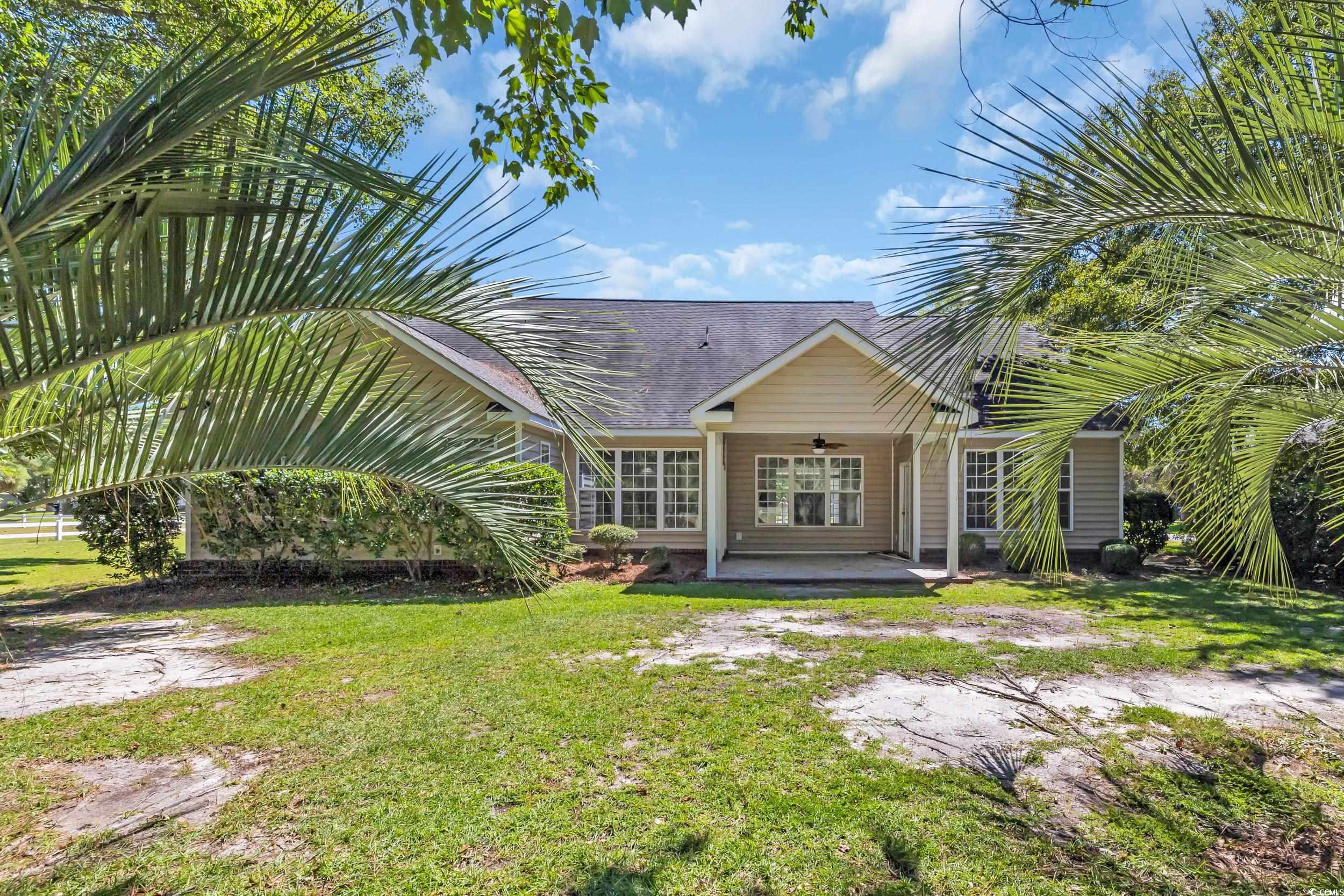 208 Lander Drive Conway, SC 29526 - Photo 35 of 40 View of front of property with ceiling fan, a patio area, a front yard, and a shingled roof