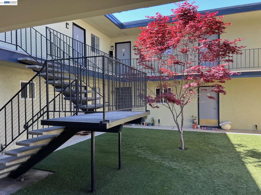 a view of a house with a small yard and a slide