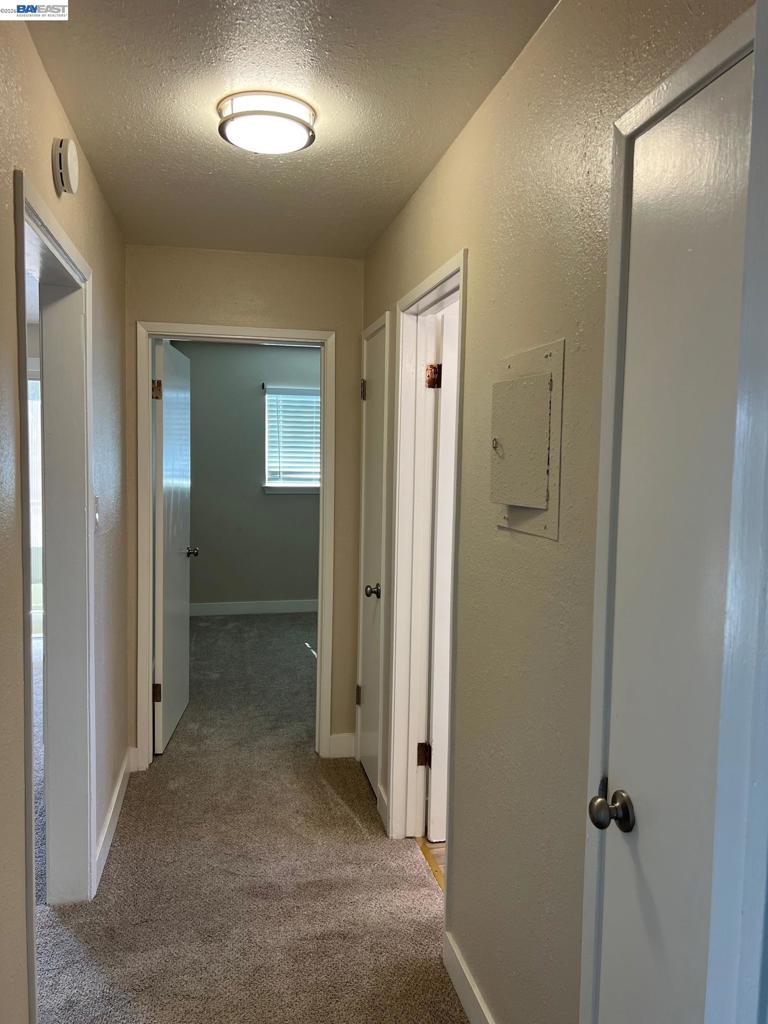 36976 Mulberry Street Newark, CA 94560 - Photo 25 of 34 a view of a hallway with wooden shelves