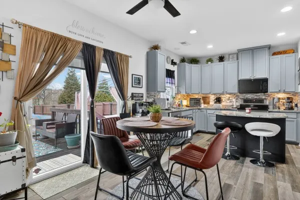 a dining room with furniture and a floor to ceiling window