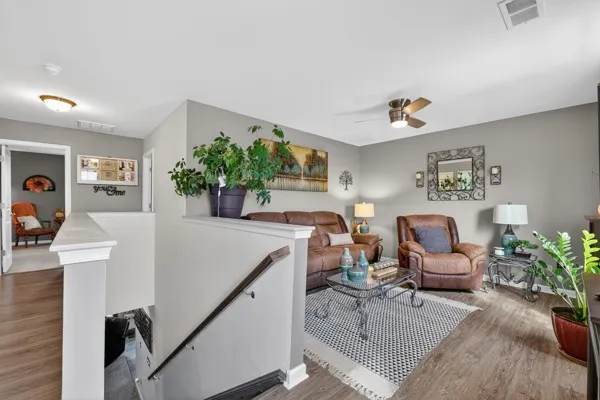a living room with furniture and flowers