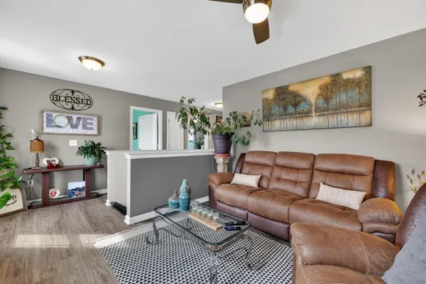 a living room with furniture and a wooden floor