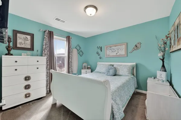 a bedroom with a bed and window