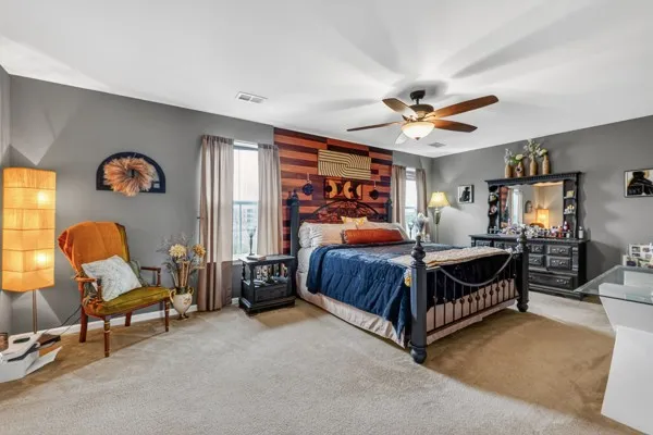 a bedroom with a bed and a chandelier