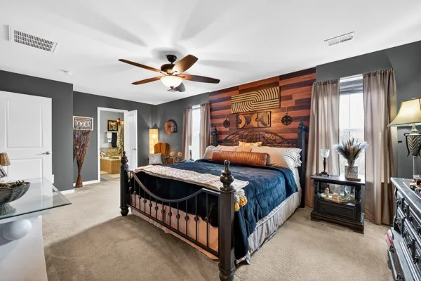 a bedroom with a bed and a chandelier