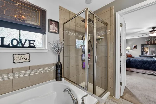 a bathroom with a tub and a shower