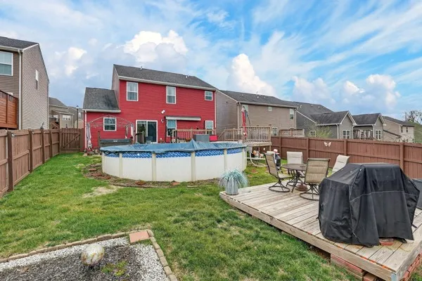 a view of a house with backyard and sitting area