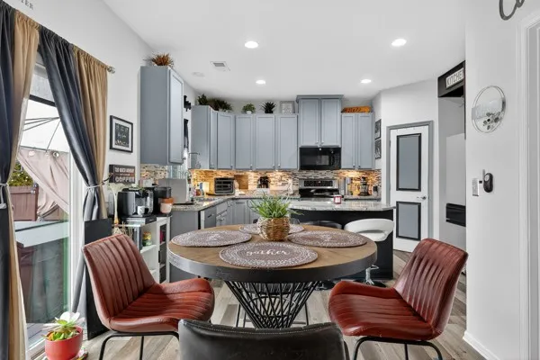 a kitchen with a dining table and chairs