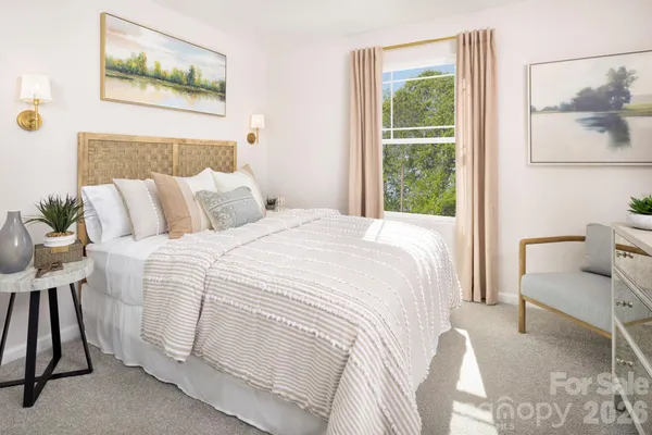 a bedroom with a bed and a painting on the wall