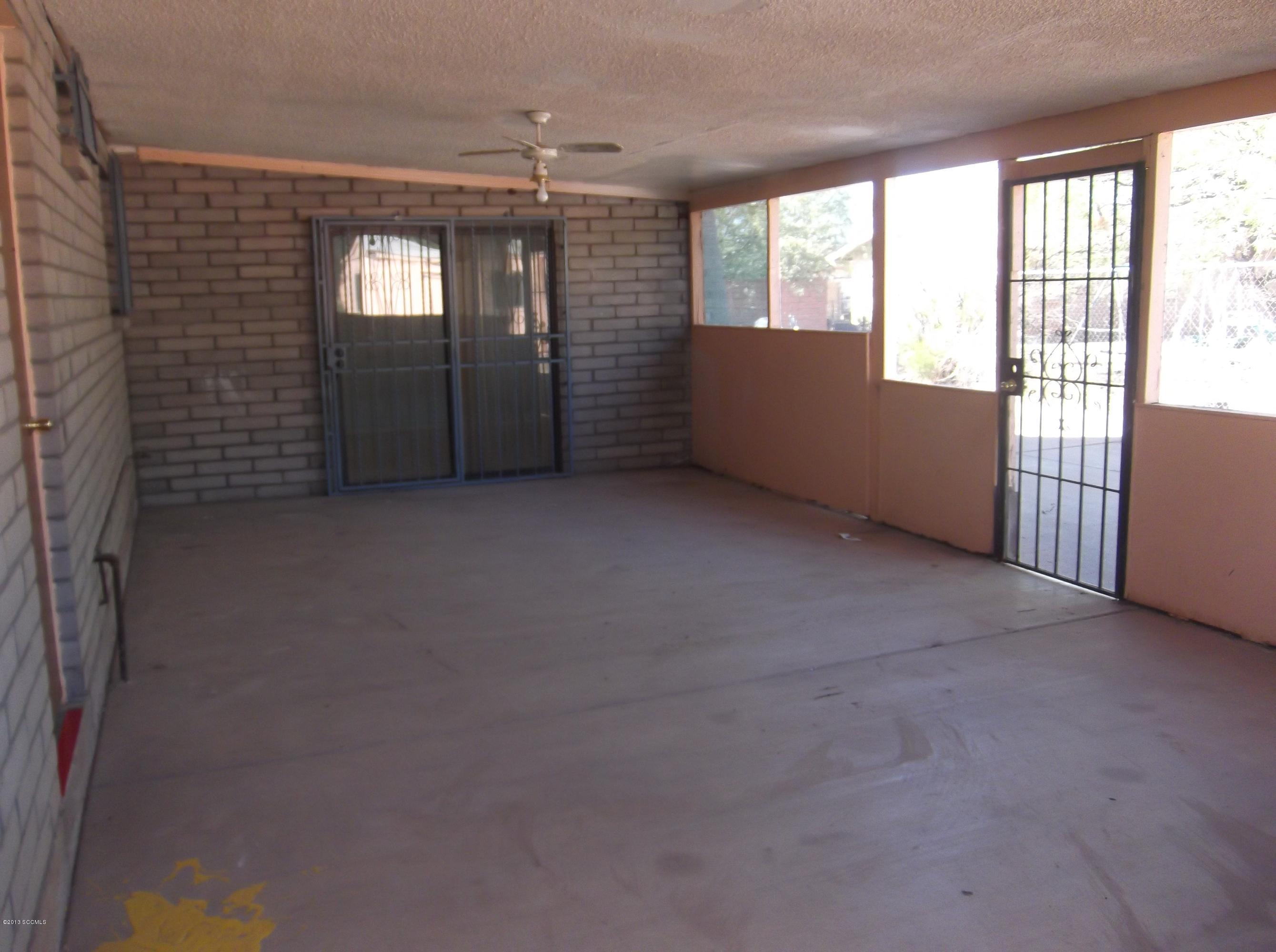 1241 Bellota Court Rio Rico, AZ 85648 - Photo 3 of 12 en empty room with windows and ceiling fan