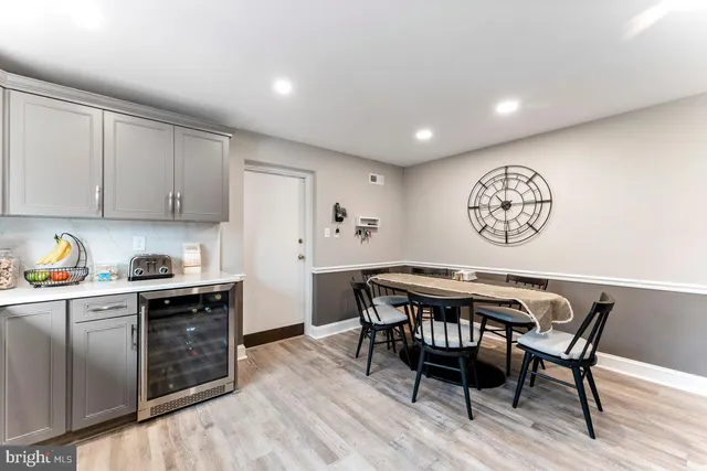 a kitchen with stainless steel appliances granite countertop a stove a sink dishwasher a refrigerator with a dining table and chairs