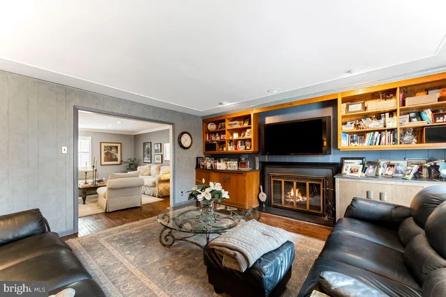 a living room with furniture a rug and a flat screen tv