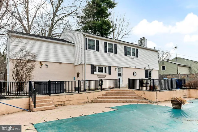 a view of backyard with wooden fence and trees