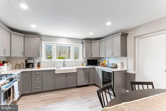 a kitchen with granite countertop stainless steel appliances and wooden cabinets