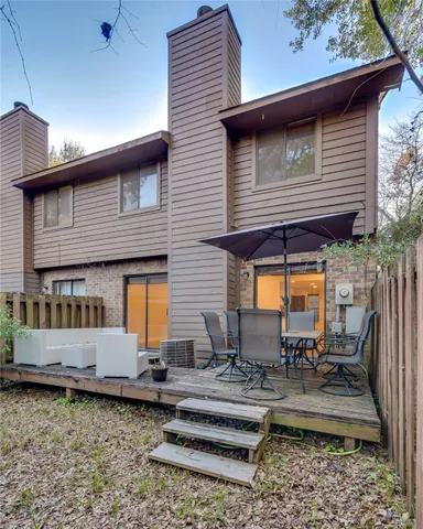 a view of backyard with outdoor seating and barbeque oven
