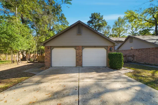 a view of a house with a yard and garage