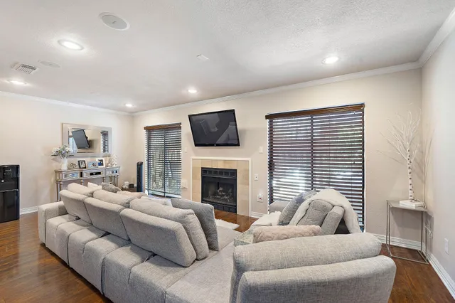 a living room with furniture flat screen tv and a fireplace