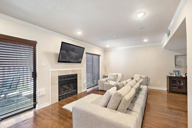 a living room with furniture a fireplace and a flat screen tv