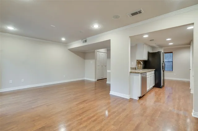 a view of a kitchen with a sink and a refrigerator