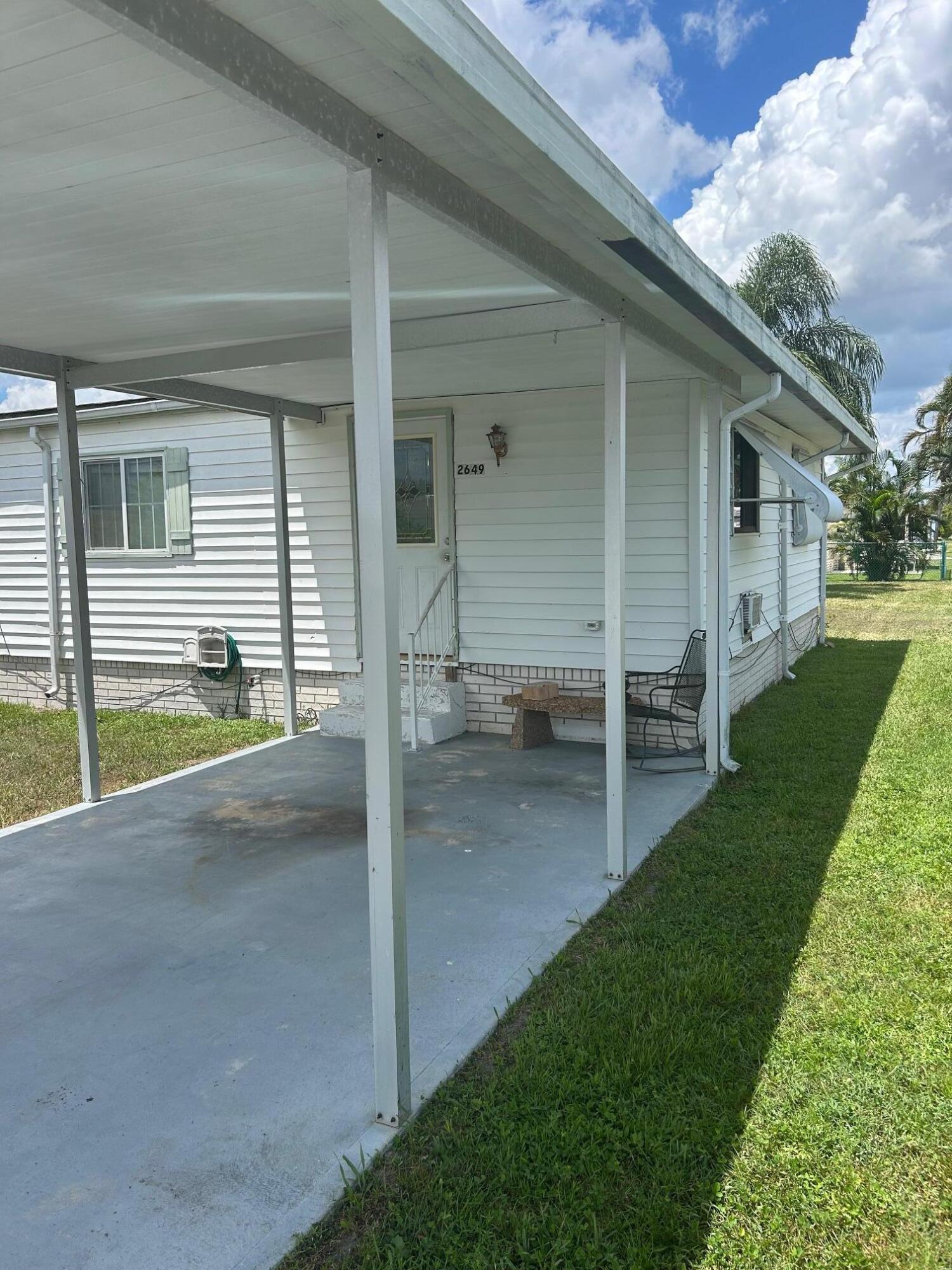 2649 Southwest Thunderbird Trail Stuart, FL 34997 - Photo 3 of 5 a view of a house with backyard and porch