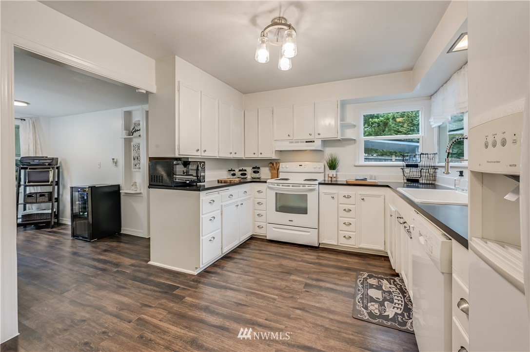19918 Filbert Drive Bothell, WA 98012 - Photo 8 of 30 a kitchen with a white cabinets and window