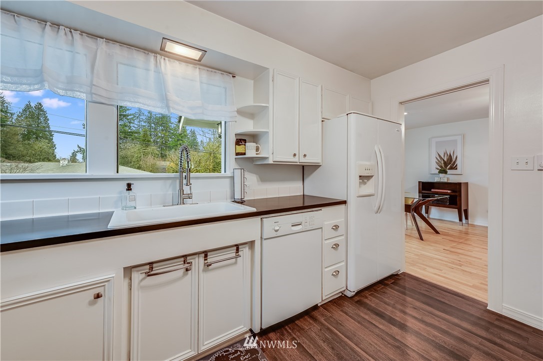 19918 Filbert Drive Bothell, WA 98012 - Photo 9 of 30 a kitchen with white cabinets and sink