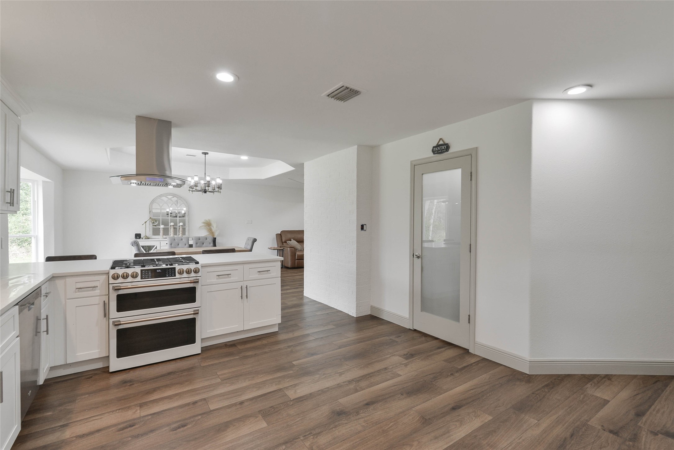 531 Brandon Road Conroe, TX 77302 - Photo 22 of 33 a kitchen with a stove and white cabinets