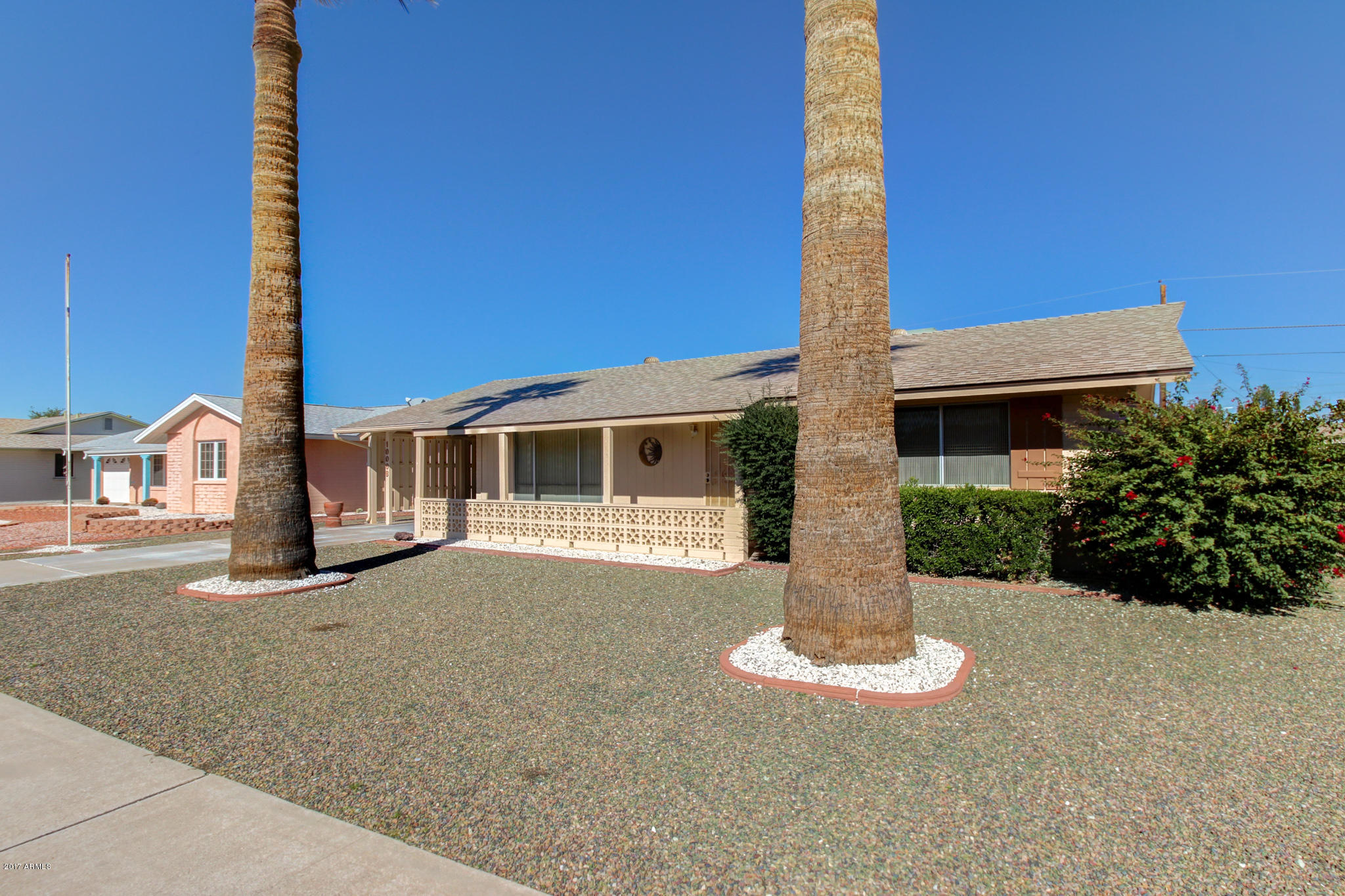 10008 West Riviera Drive Sun City, AZ 85351 - Photo 8 of 26 a front view of a house with a yard and garage