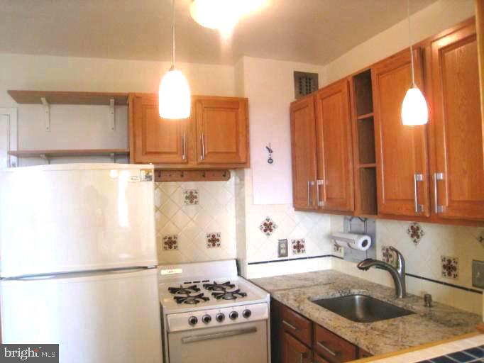 2800 Wisconsin Avenue Northwest, Unit 601 Washington, DC 20007 - Photo 11 of 23 a kitchen with a refrigerator and a sink