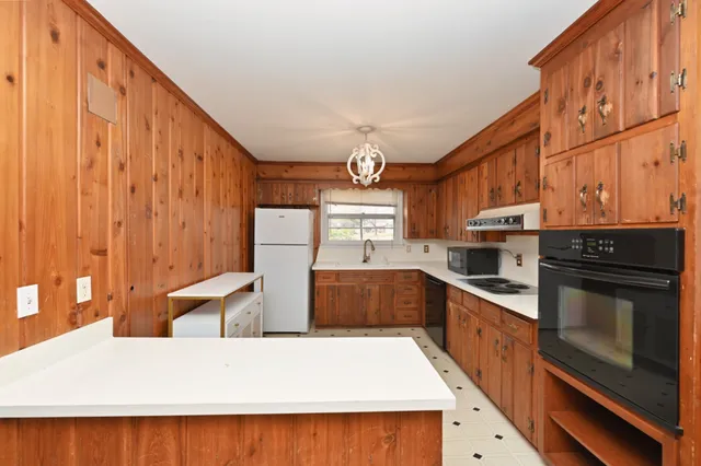 a kitchen with stainless steel appliances granite countertop a stove and a refrigerator