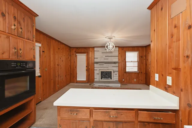 a living room with fireplace furniture and a window