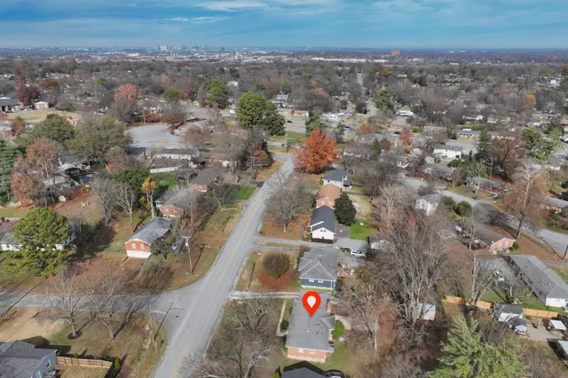 an aerial view of residential houses with outdoor space