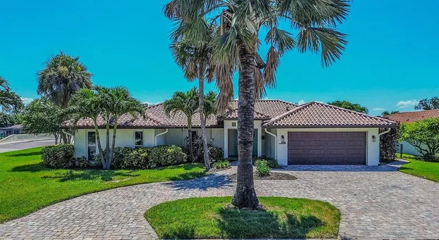 a front view of a house with a garden and plants